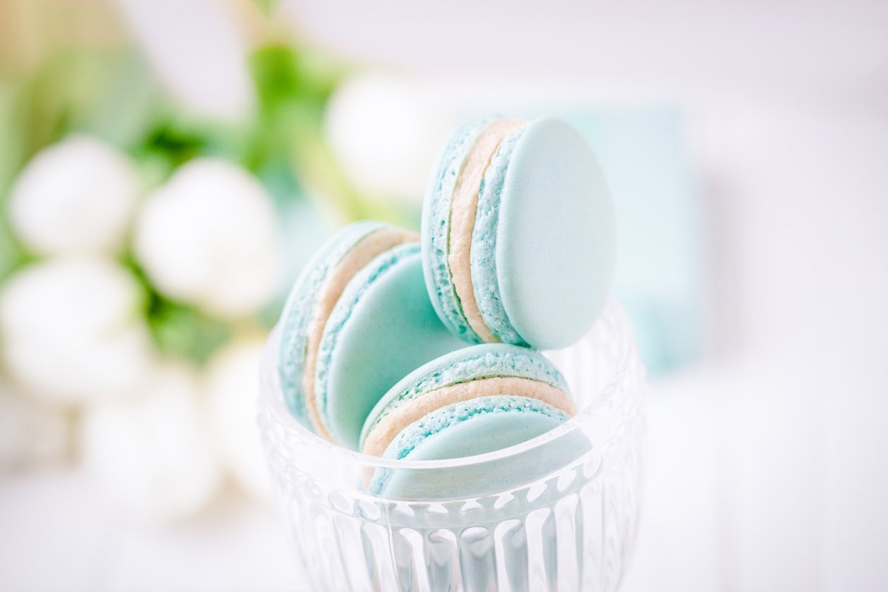 Mint or tiffany color macaron or macaroon dessert with vanilla cream in glass